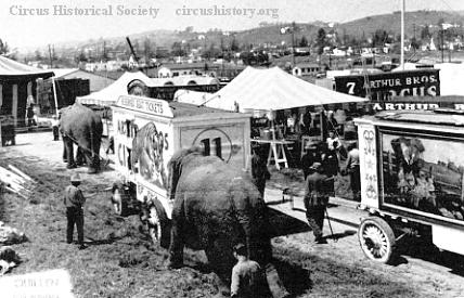 Elephant pushing ticket wagon
